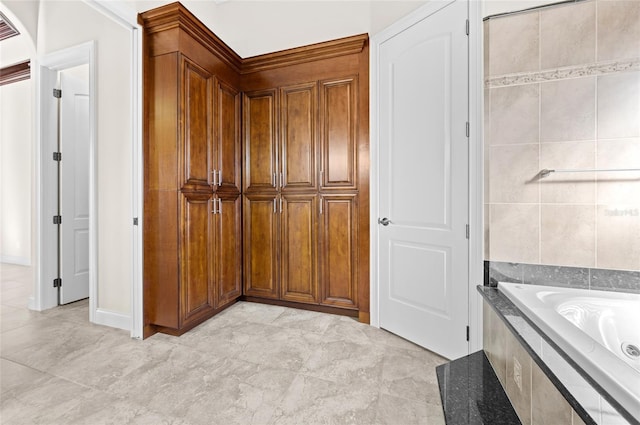 bathroom featuring tile patterned floors and tiled bath