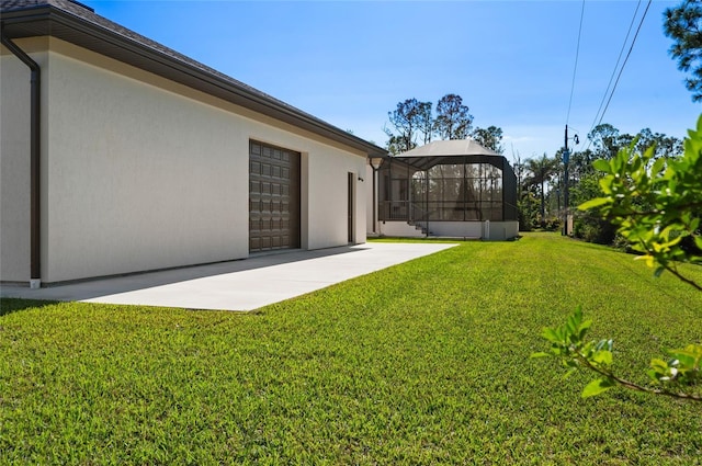 view of yard with a patio and glass enclosure