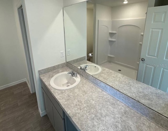 bathroom with vanity and a shower