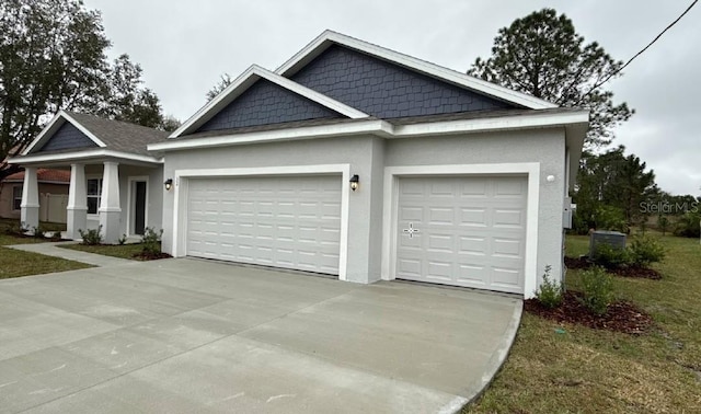 view of front of house with an attached garage, concrete driveway, and stucco siding