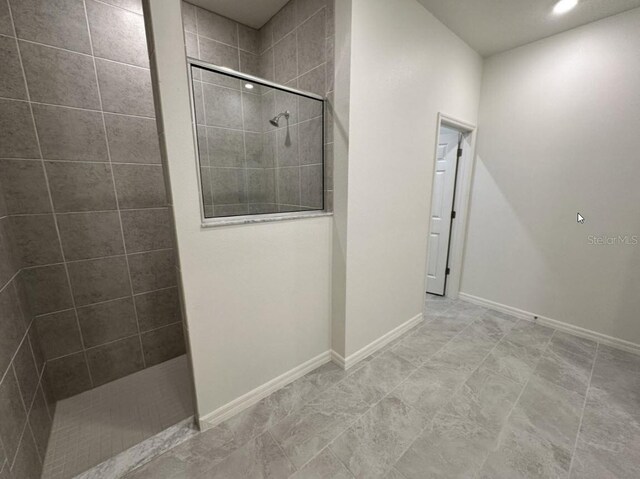 full bathroom with baseboards and walk in shower