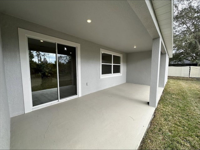 view of patio featuring fence