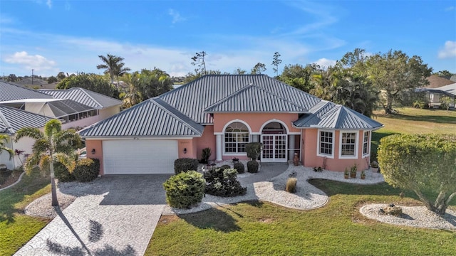 view of front of property featuring a garage and a front lawn