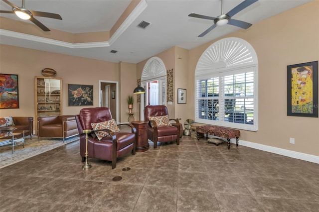 sitting room with ceiling fan, ornamental molding, and a tray ceiling