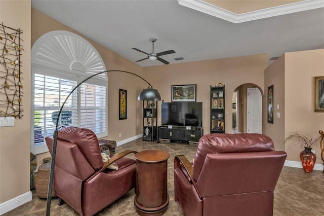 living room with ceiling fan and ornamental molding