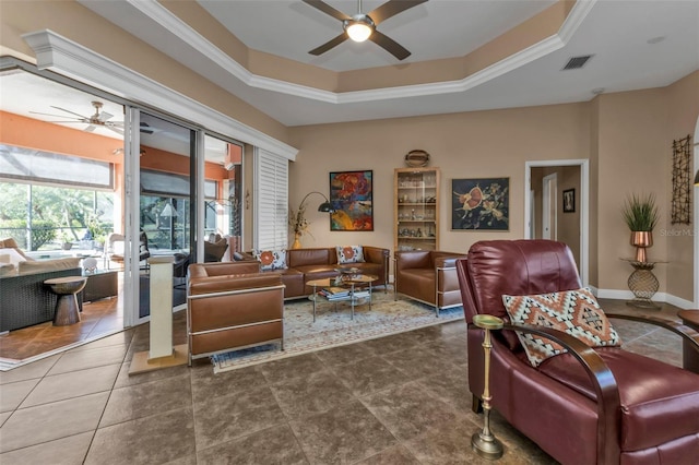 living room featuring ceiling fan, a raised ceiling, and ornamental molding