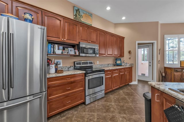 kitchen featuring light stone countertops and appliances with stainless steel finishes