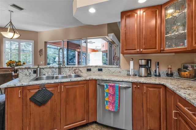 kitchen featuring pendant lighting, sink, stainless steel dishwasher, ceiling fan, and light stone counters