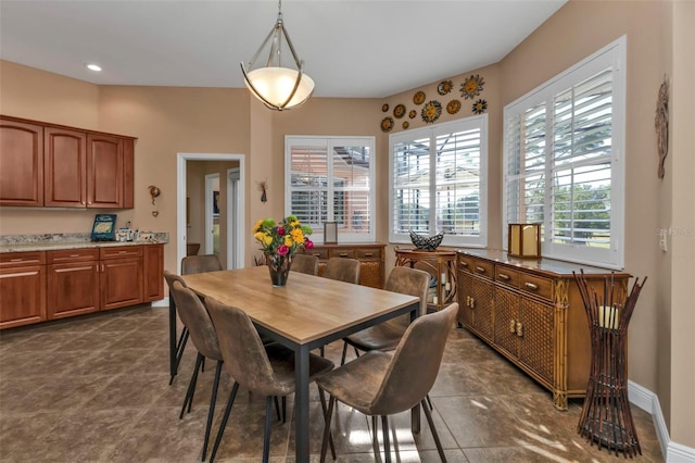 dining area featuring dark tile patterned floors