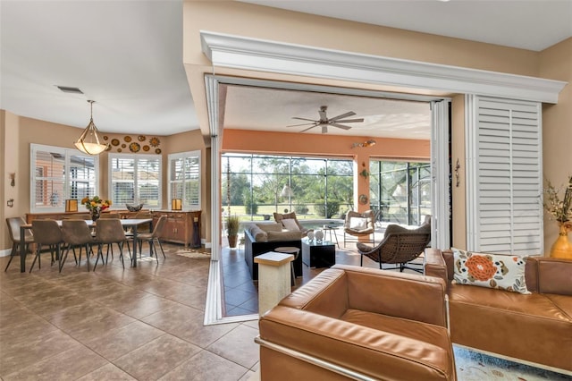 living room with tile patterned flooring and ceiling fan