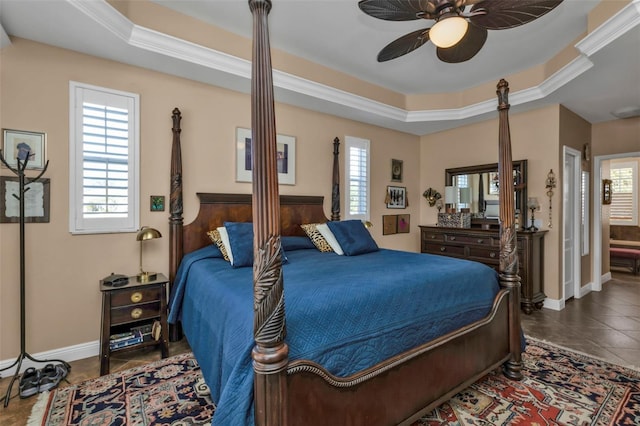 tiled bedroom featuring a raised ceiling, ceiling fan, and crown molding