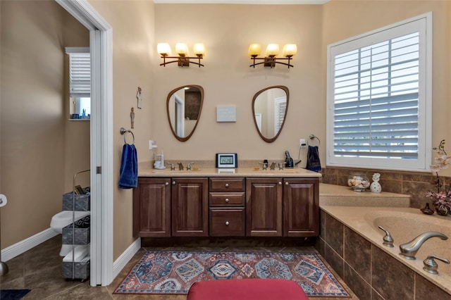 bathroom featuring tile patterned flooring, vanity, tiled bath, and plenty of natural light