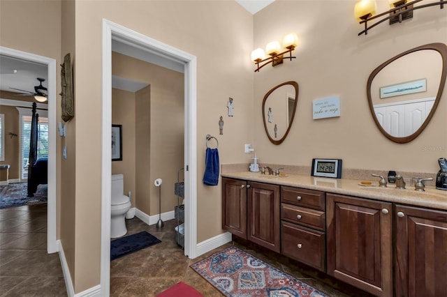 bathroom with ceiling fan, tile patterned flooring, vanity, and toilet