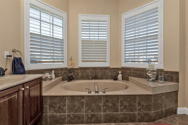 bathroom with vanity and a relaxing tiled tub