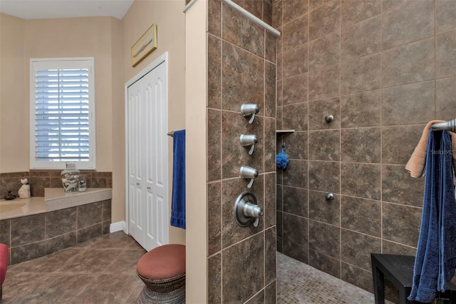 bathroom featuring tile patterned flooring and tiled shower