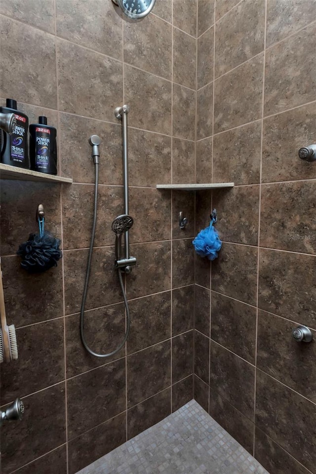 bathroom with tiled shower