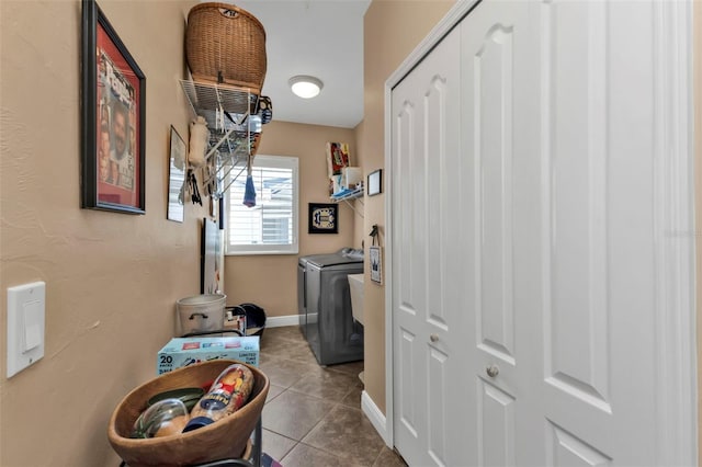 clothes washing area featuring tile patterned flooring and independent washer and dryer