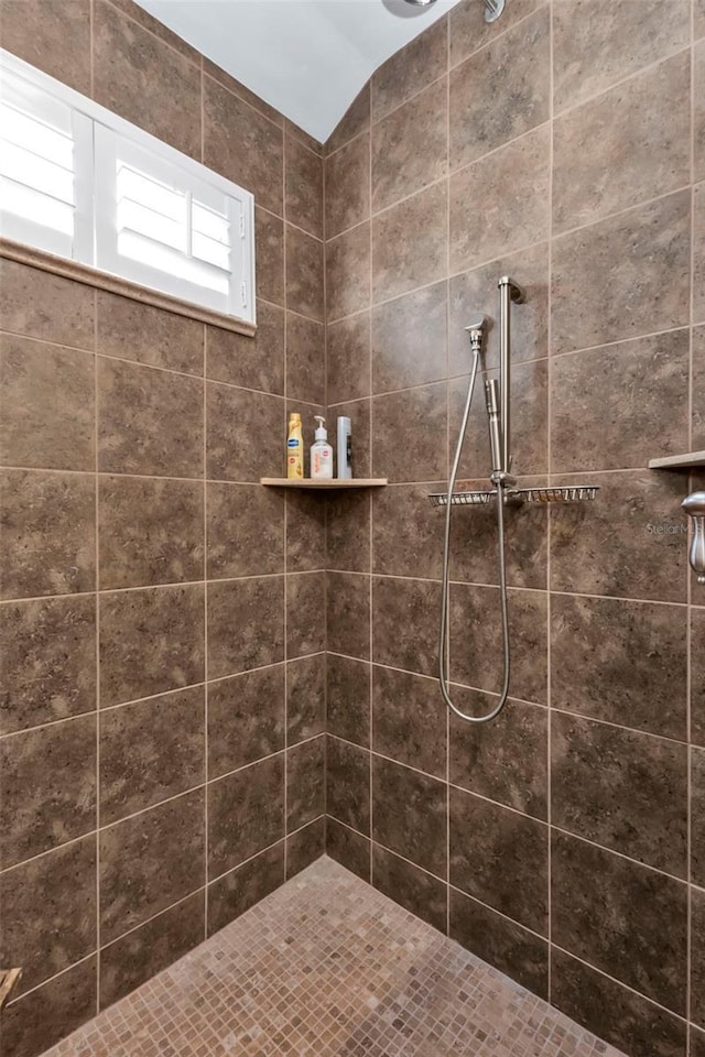 bathroom with tiled shower