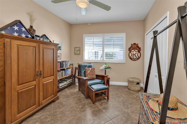 sitting room with tile patterned flooring and ceiling fan