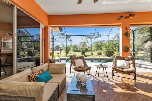 sunroom with ceiling fan and a swimming pool