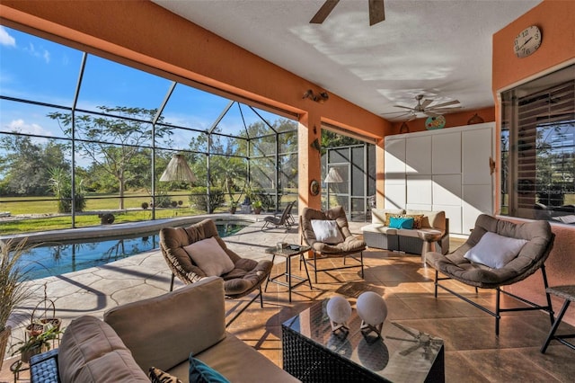 sunroom featuring ceiling fan and a swimming pool