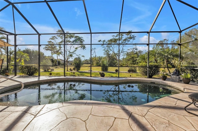 view of swimming pool with a lanai and a patio