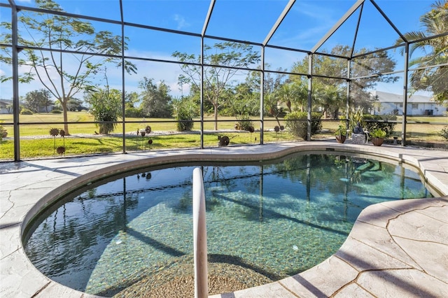 view of pool with a lanai, a yard, and a patio