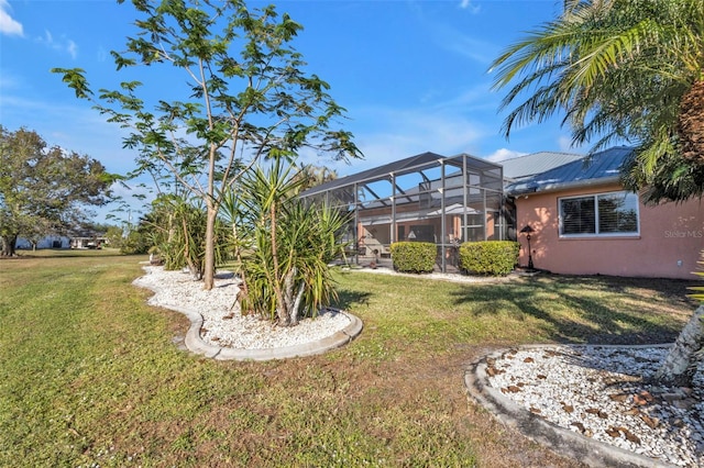 view of yard with glass enclosure