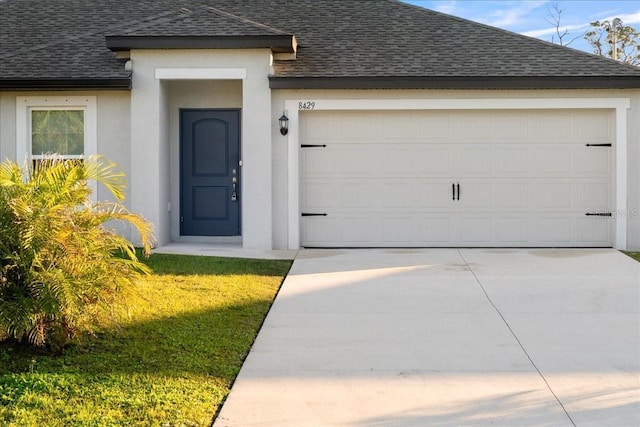 property entrance featuring a yard and a garage