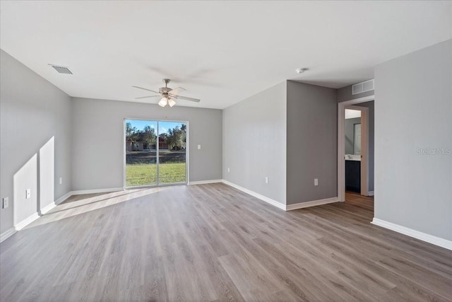 empty room with ceiling fan and light wood-type flooring