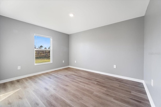 unfurnished room with light wood-type flooring