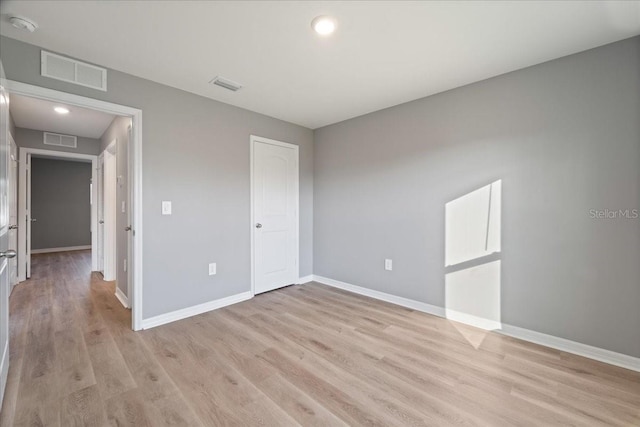 unfurnished bedroom with a closet and light wood-type flooring