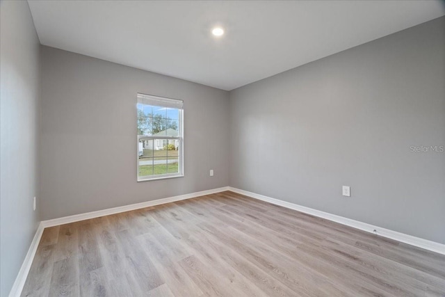 unfurnished room with light wood-type flooring