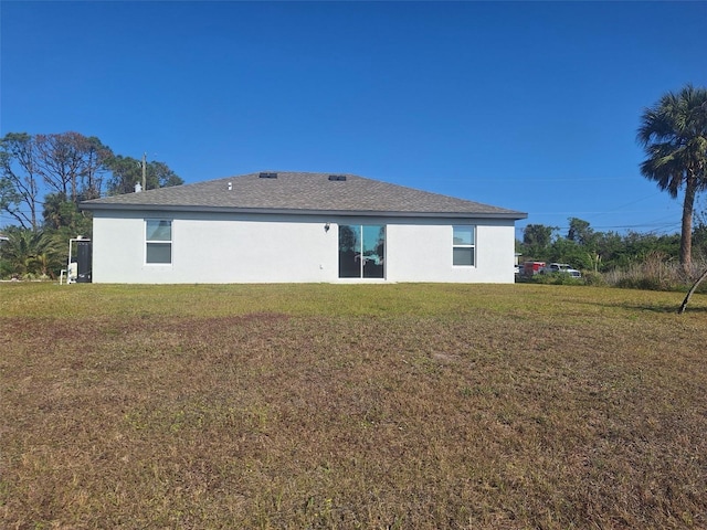 rear view of house featuring a yard