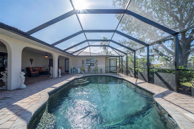 view of pool with a lanai, ceiling fan, a patio, and an outdoor hangout area