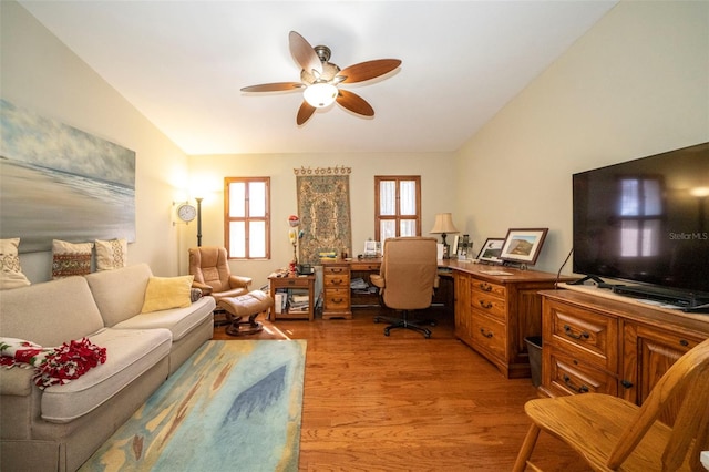 home office with light hardwood / wood-style flooring, ceiling fan, and lofted ceiling