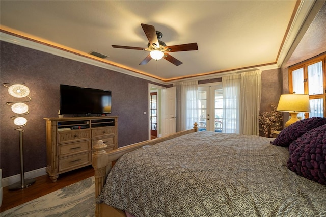 bedroom featuring french doors, dark hardwood / wood-style floors, ceiling fan, and ornamental molding