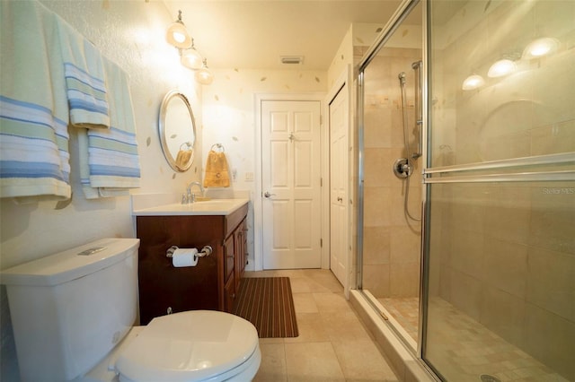 bathroom featuring an enclosed shower, vanity, and toilet