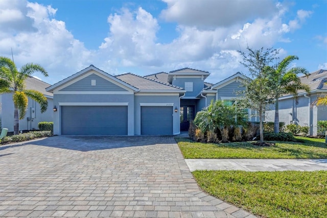 view of front of property with a garage and a front lawn