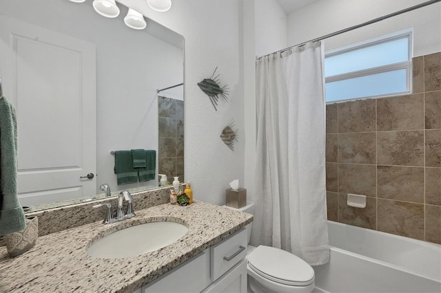 full bathroom featuring shower / bath combo with shower curtain, vanity, and toilet