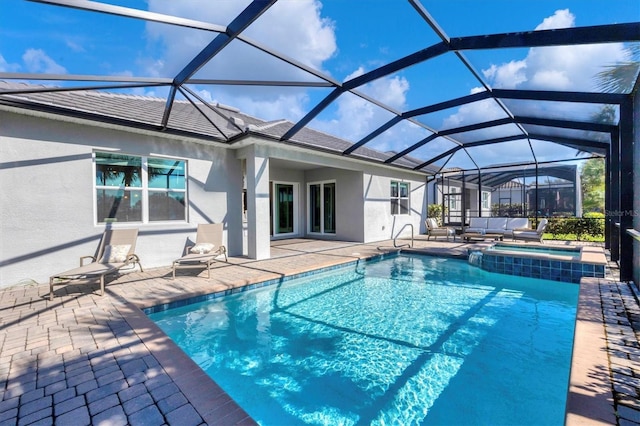 view of swimming pool with an in ground hot tub, a patio, and a lanai