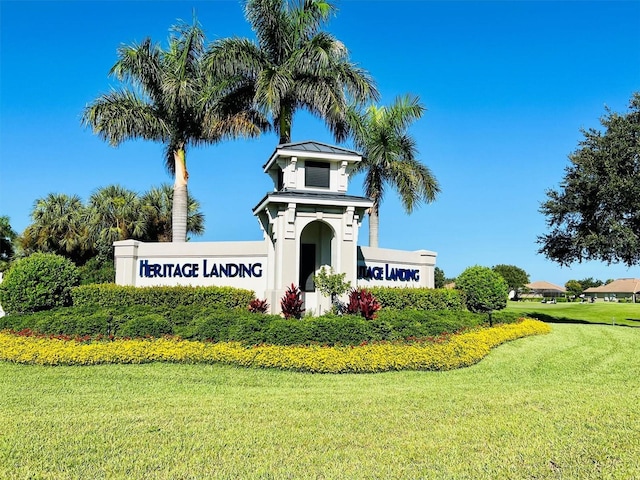 community sign featuring a lawn