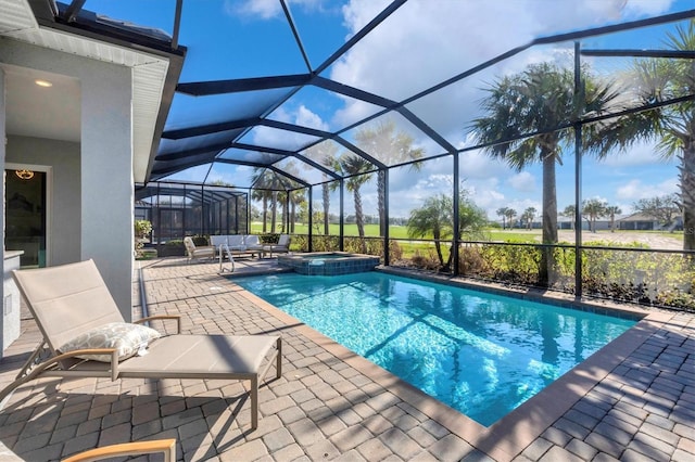 view of pool with outdoor lounge area, glass enclosure, an in ground hot tub, and a patio