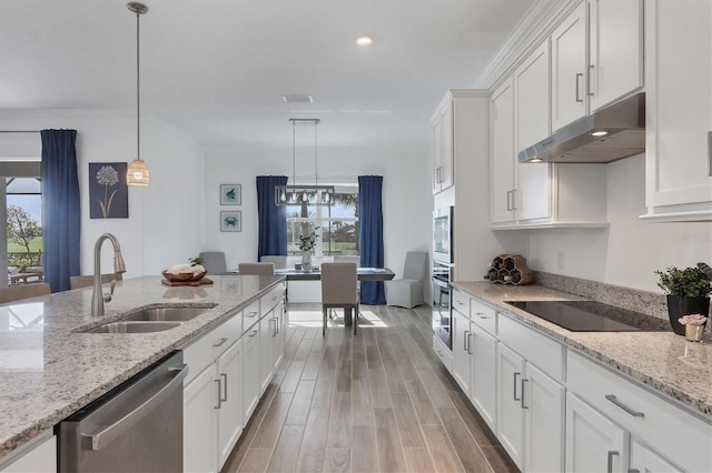 kitchen with white cabinetry, sink, stainless steel appliances, decorative light fixtures, and ornamental molding