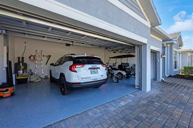 garage with a garage door opener and water heater