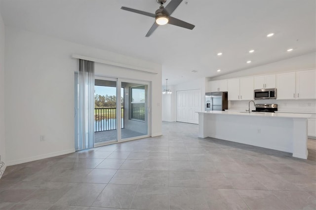 12470 Wellen Golf St Unit 203, Venice, FL 34293 - kitchen featuring appliances with stainless steel finishes, white cabinetry, lofted ceiling, a kitchen island with sink, and light tile patterned floors