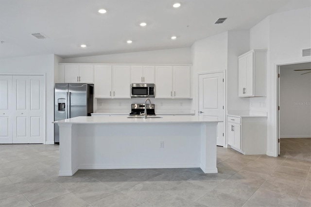 12470 Wellen Golf St Unit 203, Venice, FL 34293 - kitchen featuring lofted ceiling, sink, white cabinetry, stainless steel appliances, and a kitchen island with sink
