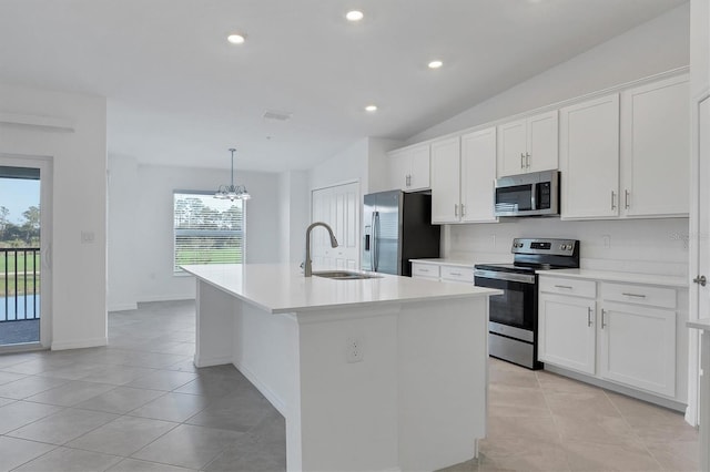 12470 Wellen Golf St Unit 203, Venice, FL 34293 - kitchen with white cabinetry, appliances with stainless steel finishes, sink, and an island with sink