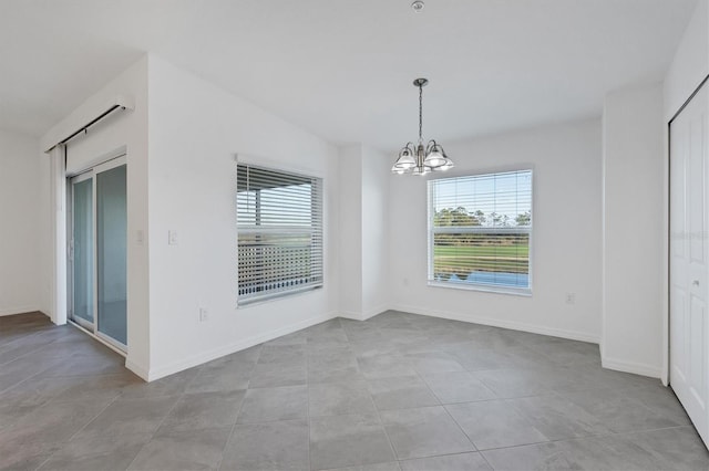 12470 Wellen Golf St Unit 203, Venice, FL 34293 - unfurnished dining area with light tile patterned floors and an inviting chandelier