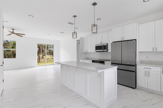 kitchen featuring a kitchen island, white cabinets, pendant lighting, and appliances with stainless steel finishes